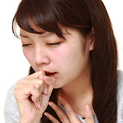woman coughing due to bronchitis